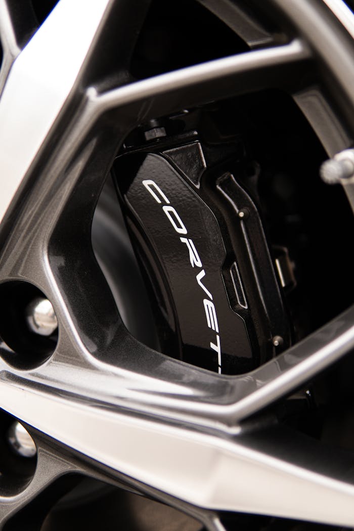 Detailed view of a Corvette's brake caliper through the wheel rim. Perfect for automotive enthusiasts.