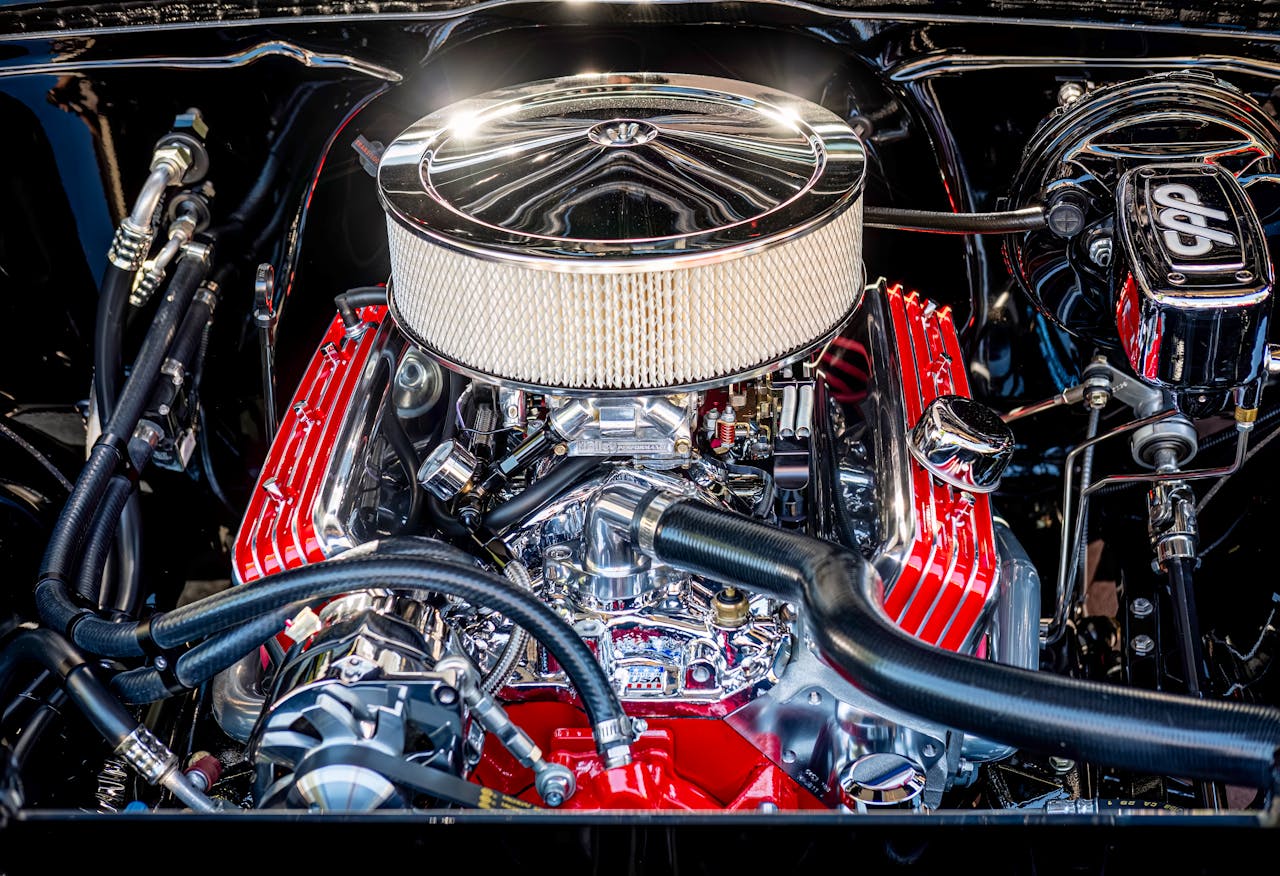 Close-up of a polished and high-performance car engine with visible components and pipes.